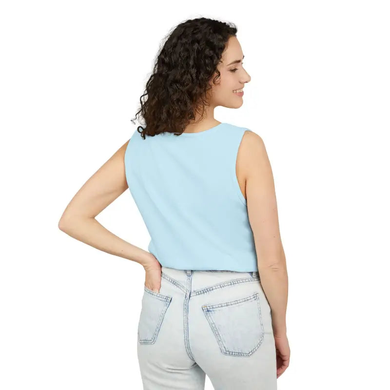 Woman wearing a light blue tank top and jeans, showcasing Sunflower Tank Tops in Teal
