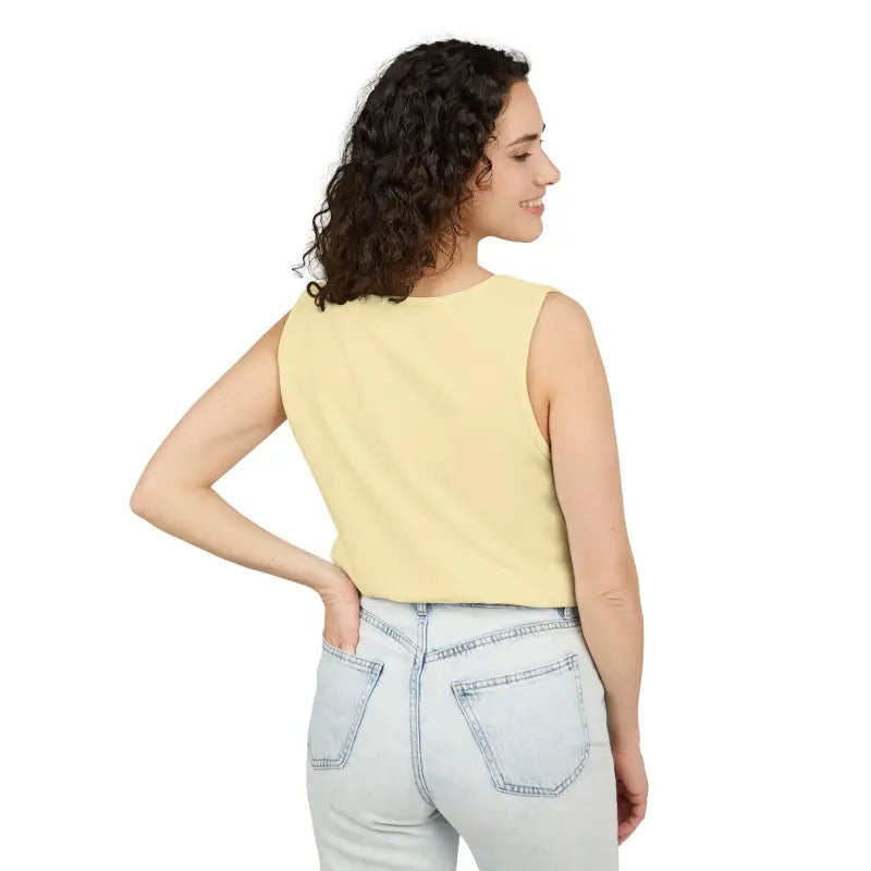 Woman wearing a yellow tank top and light blue jeans representing Sunflower Tank Tops collection