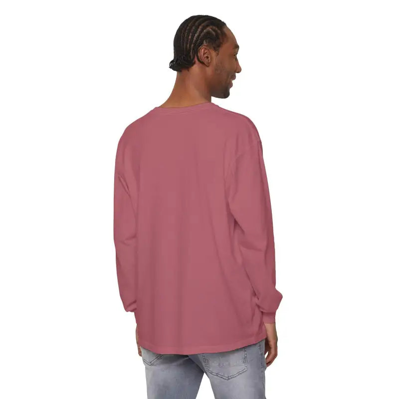 Man wearing a long-sleeved rose-colored shirt featuring a sailboat graphic design