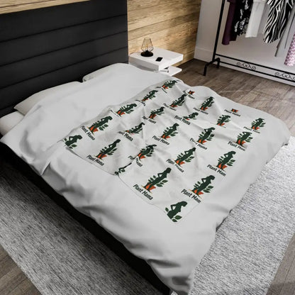 White Velveteen Plush Blanket with Plant Mama Pattern displayed elegantly