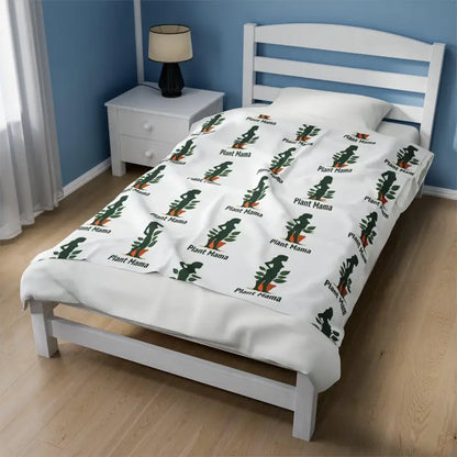 Twin bed adorned with White Velveteen Plush Blanket featuring Plant Mama pattern