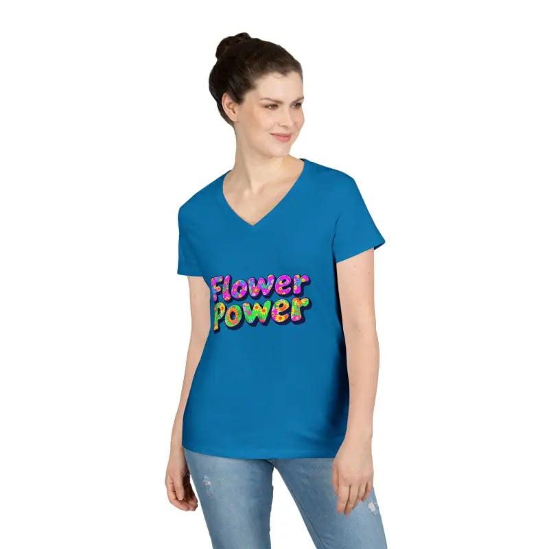Woman wearing a short-sleeved blue V-neck T-shirt with flower power colorful bubble lettering